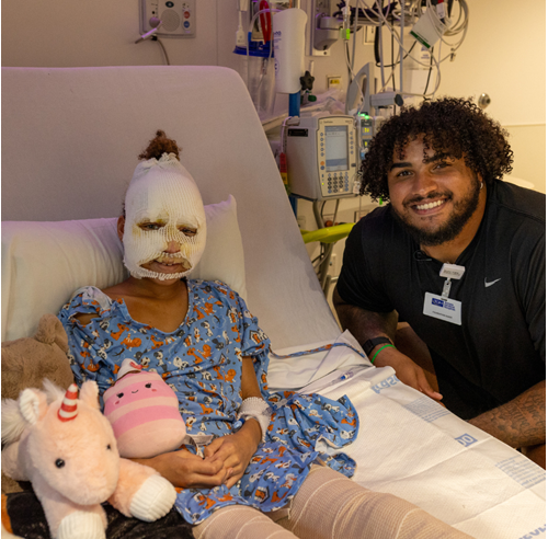 Tristan Wirfs visiting with a Muma Children's Hospital patient during the holidays last year.