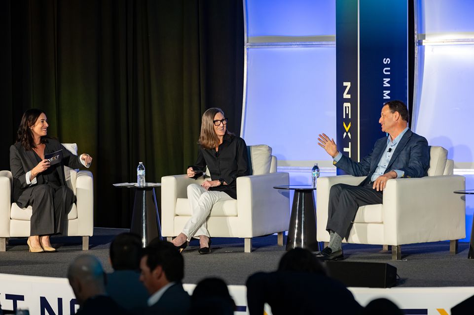 Cathie Wood, Chief Executive Officer and Chief Investment Officer of Arc Invest, talks with John Couris, President and CEO of Florida Health Sciences Center, and Rachel Feinman during the NEXT Summit on Feb. 11, 2026 at the JW Marriott on Water Street in Tampa.