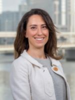 nicole justice headshot with river and downtown tampa in background