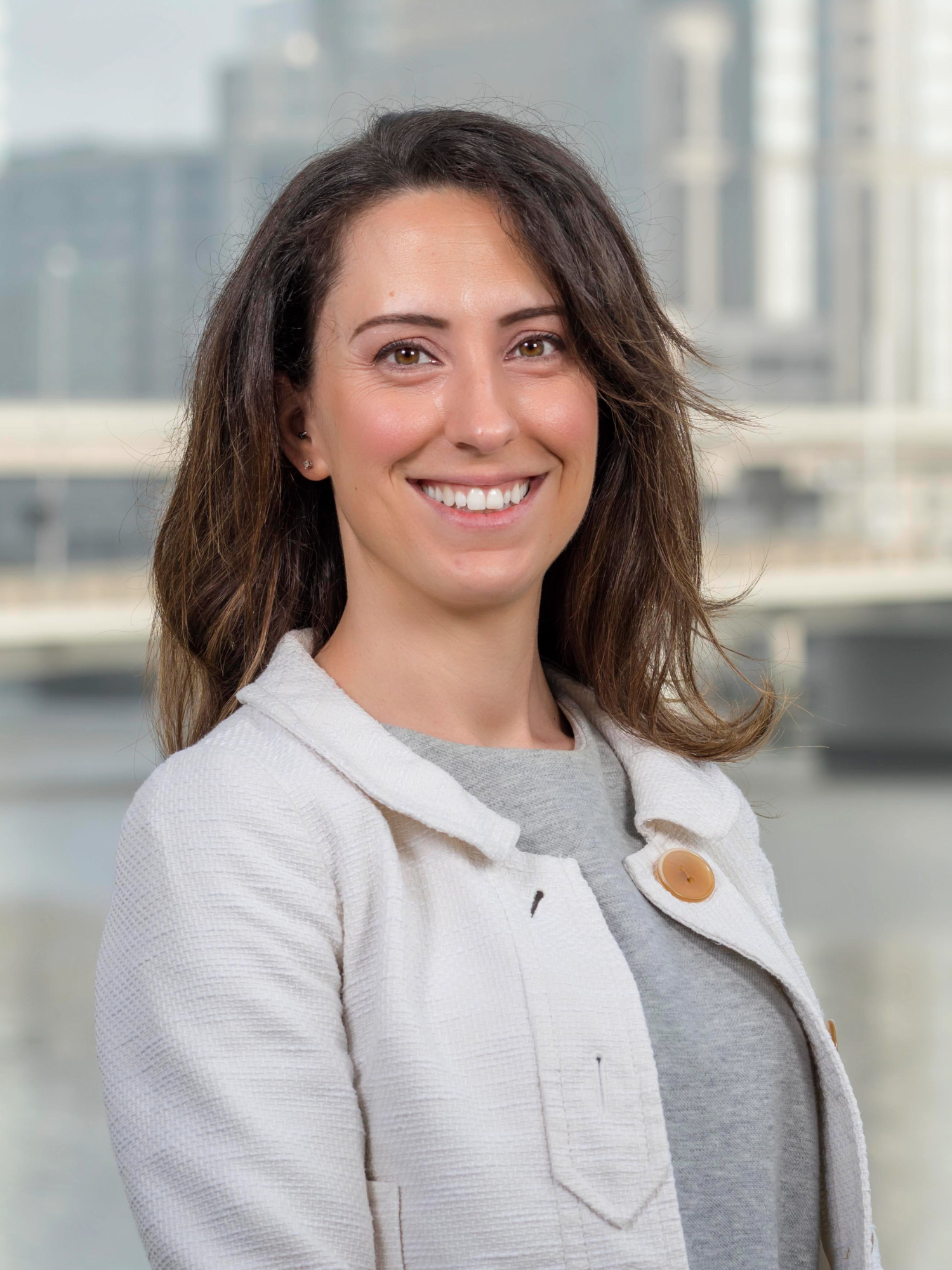 nicole justice headshot with river and downtown tampa in background