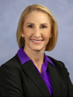 stacey brandt headshot with gray studio backdrop