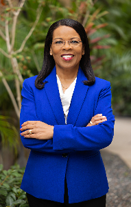 headshot image of Wendi Goodson-Celerin, DNP, APRN, NE-BC with tgh garden in background