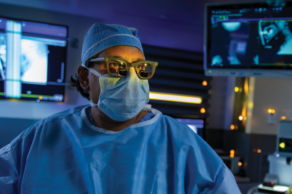 closeup photo of tgh physician dr tapan padhya in a dimly lit operating room