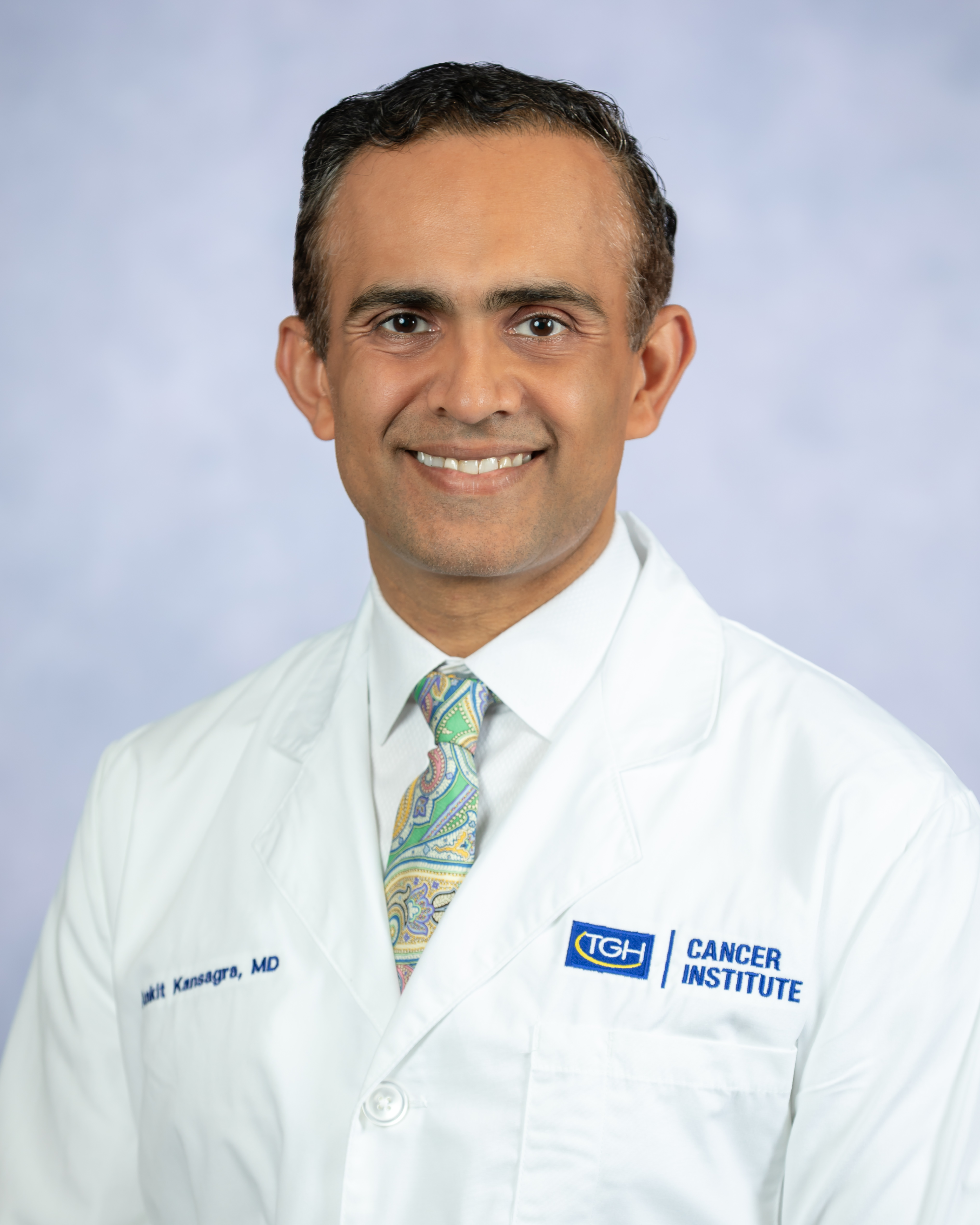 Portrait of a TGH cancer care provider, Dr. Ankit Kansagra, in a white lab coat against a light background.