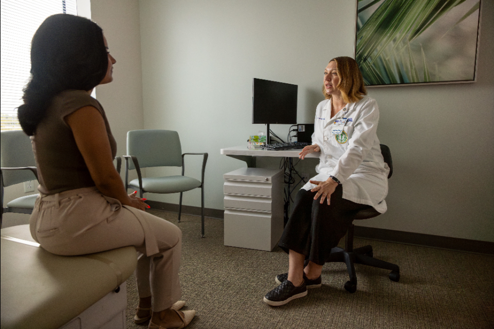 Dr. Kayla M. Forrester speaks with a female palliative care patient in her office at the TGH Cancer Institute