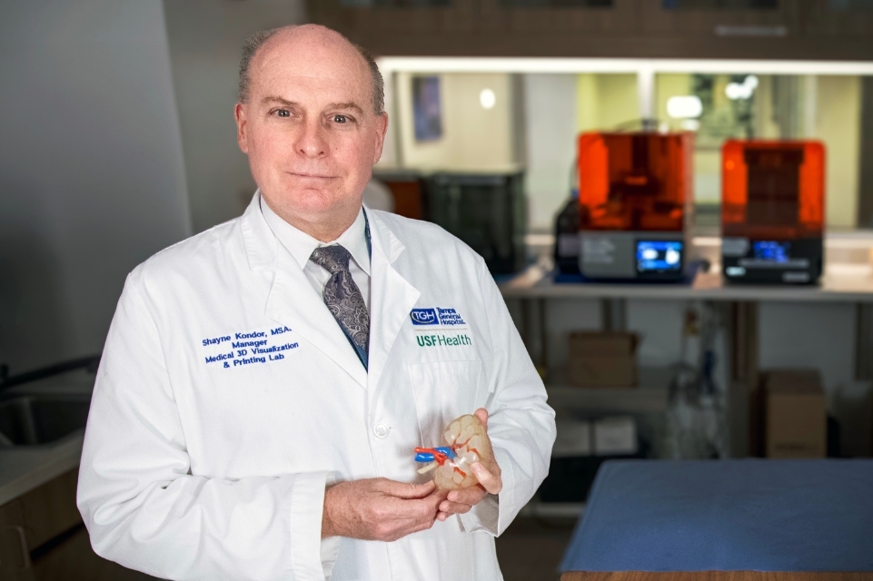 Shayne Konder,  manager of the TGH USF Health 3D Innovations Lab, photographed  at the TGH USF Health 3D Innovations Lab in Tampa General Hospital, holding a 3d model