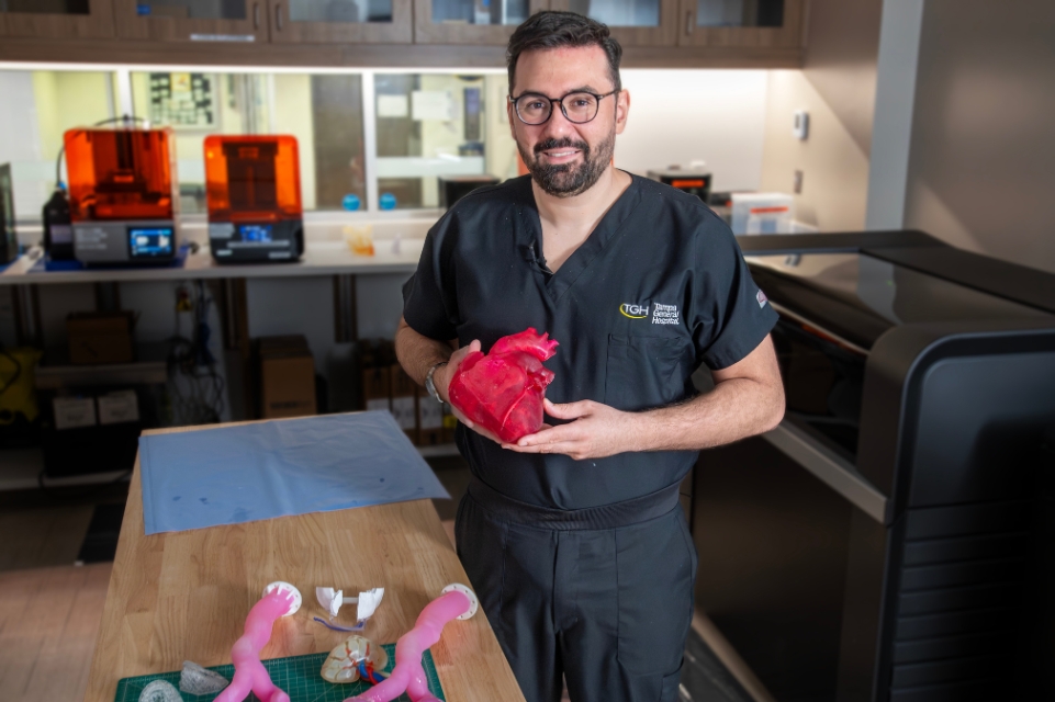 Dr. Zillle, an assistant professor in the USF Health Morsani College of Medicine, department of radiology, and director of the TGH USF Health 3D Innovations Lab holding a model of a human heart.