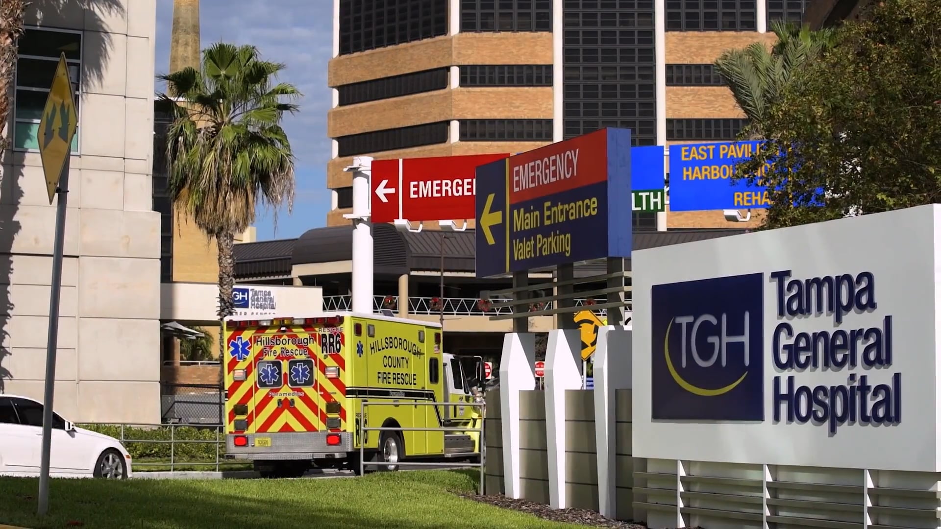 tampa general hospital emergency department signage on main campus with ambulance on road