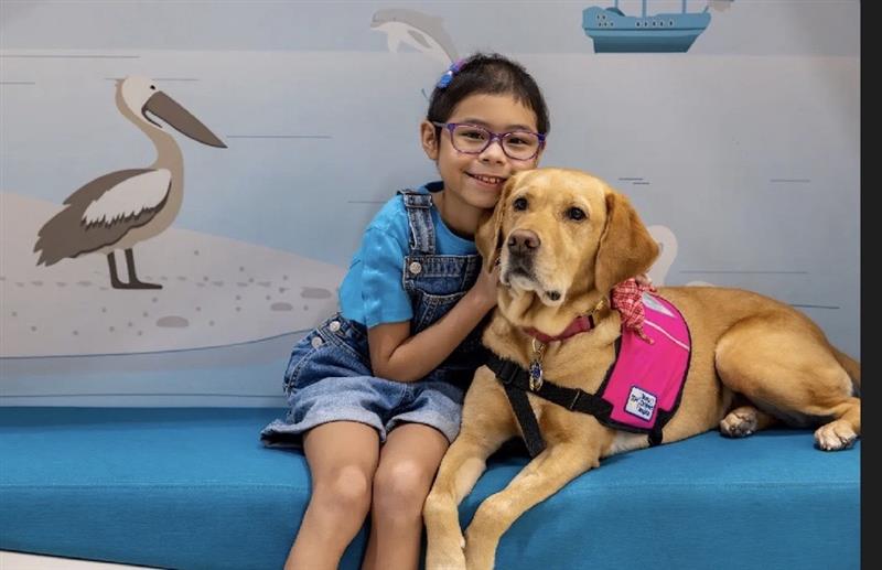 Patient April visits with Millie, chief snuggle officer at Muma Children's Hospital at TGH