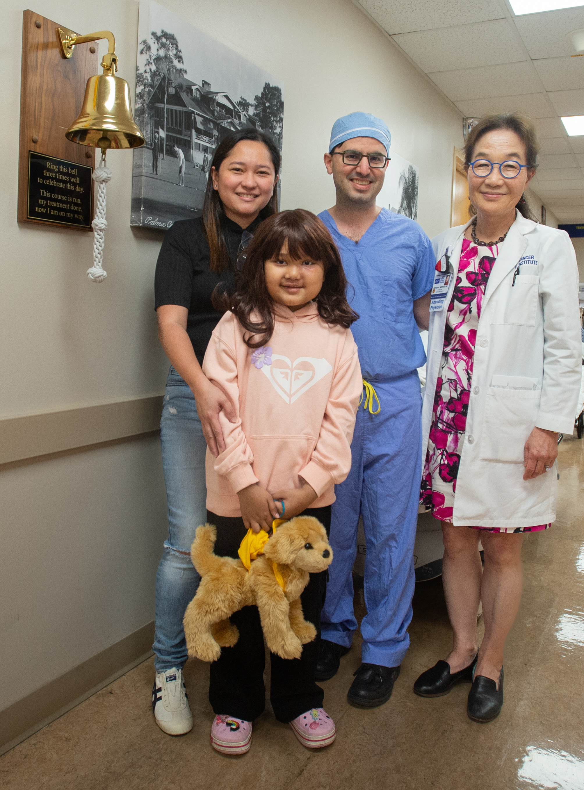 Pediatric patient and her mother with physicians that treated her.