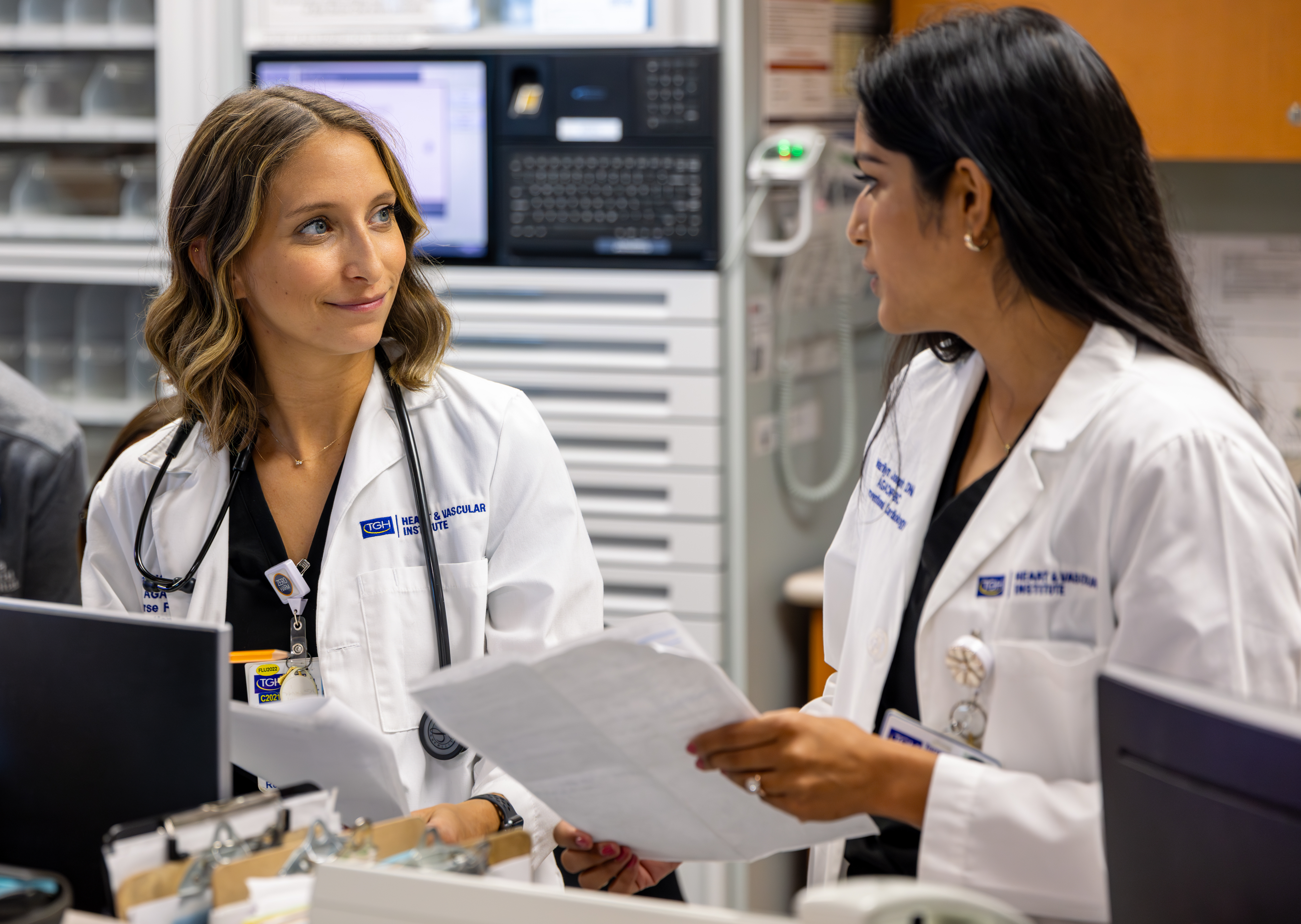 Nurse practitioners Sarah Kossiver, left, and Marilyn Joseph talk at the 3k nurse's station at Tampa General Hospital.