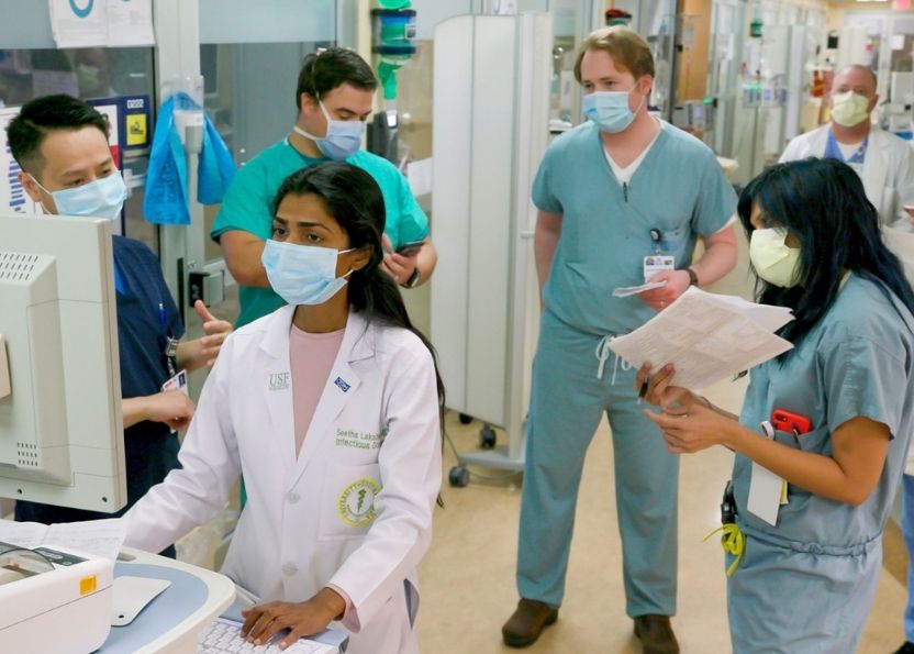 Dr. Seetha Lakshmi surrounded by multidisciplinary team