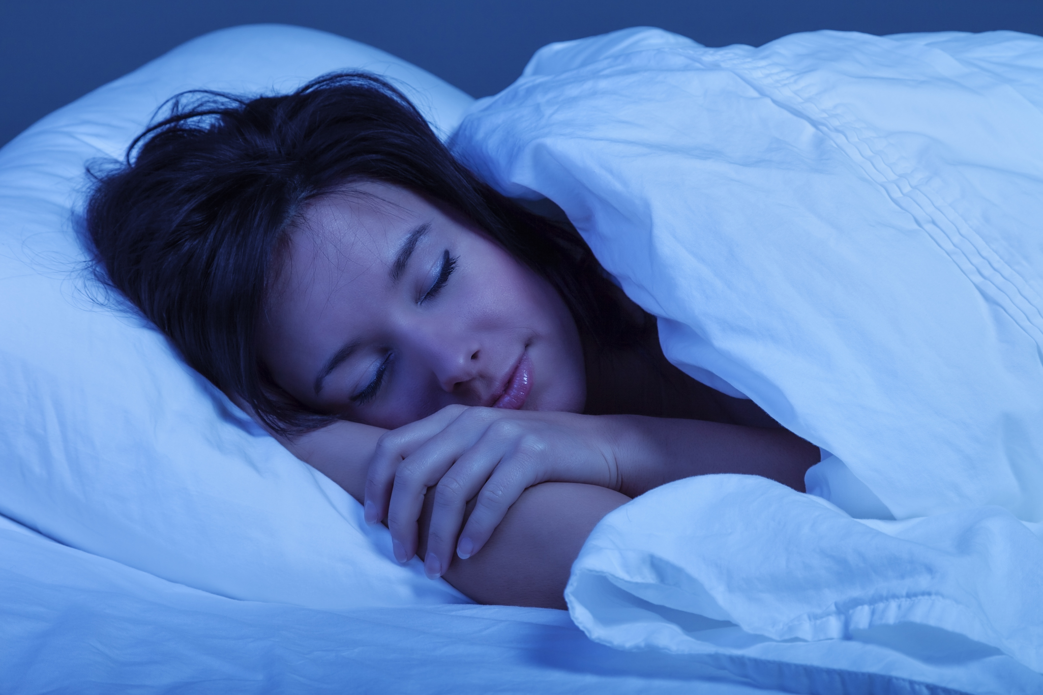 photo of a young woman sound asleep during the night