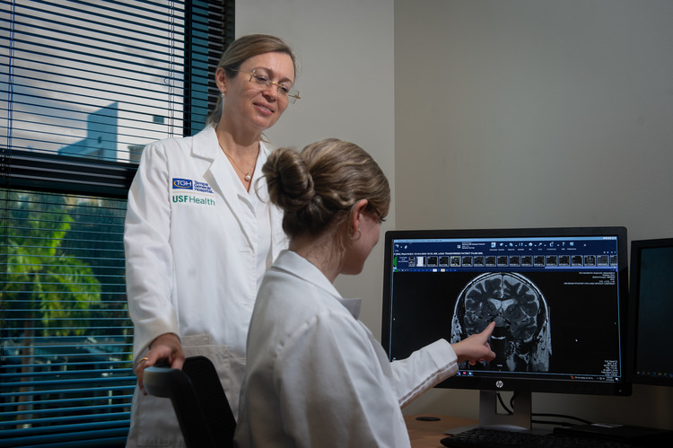 Dr. Yevgeniya Kushchayeva discussing endocrinology scans with colleague. 