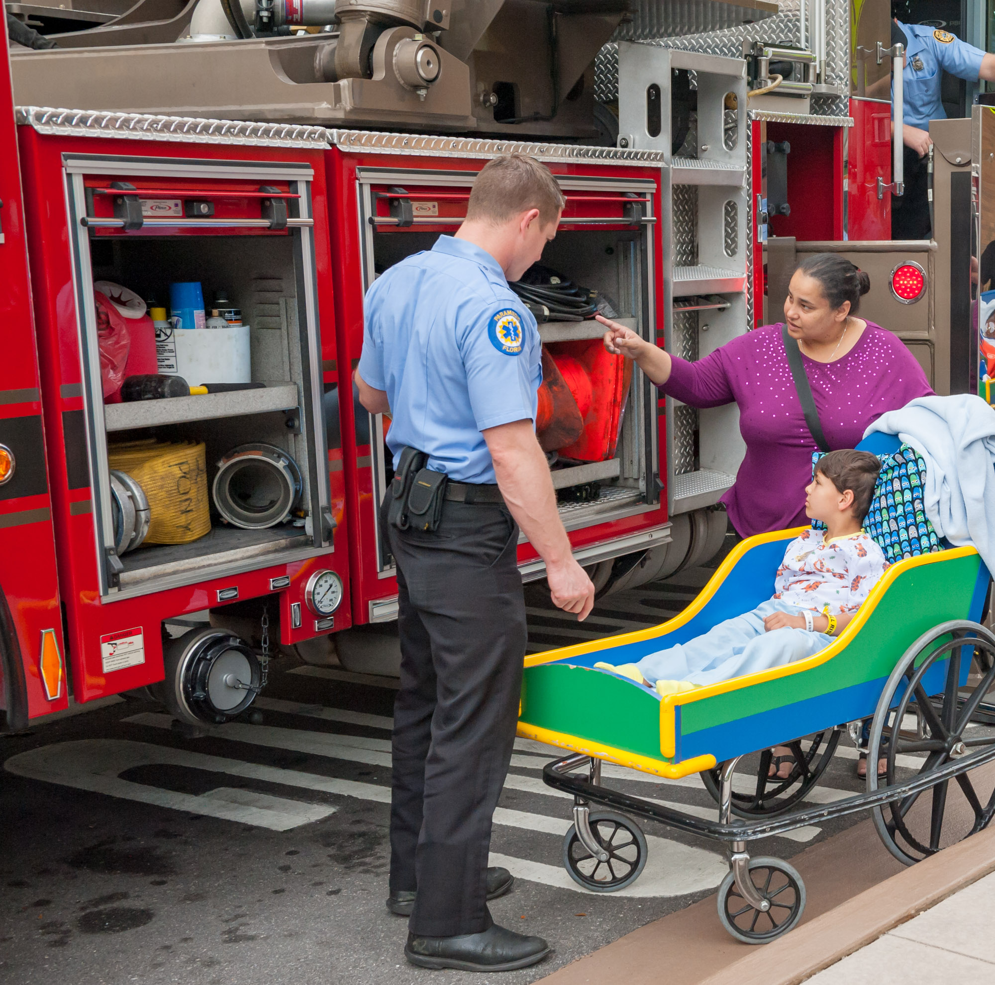 Young male patient getting a tour of the firetruck