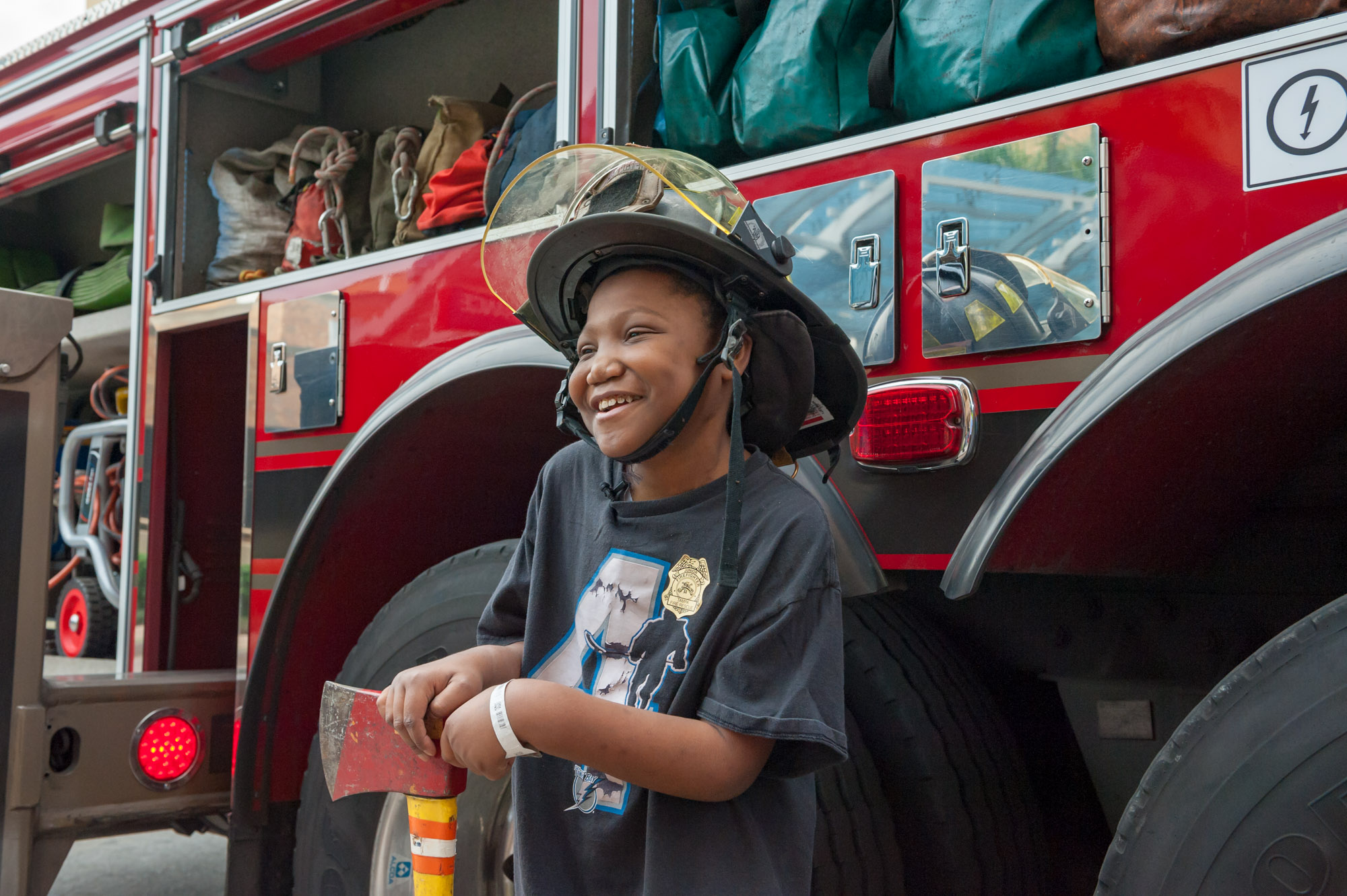 Young male patient trying on the firefighters hat