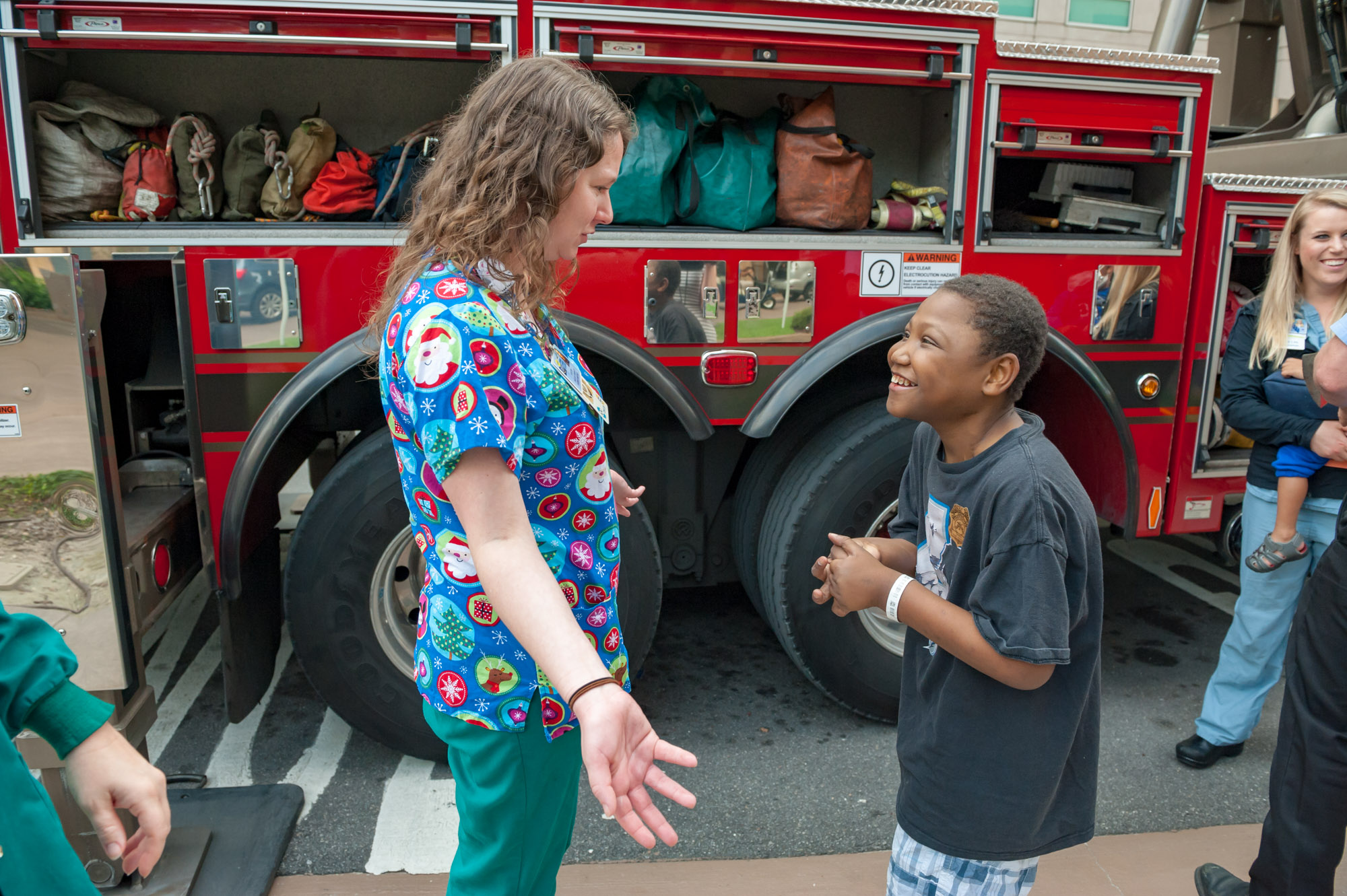 Young male patient talking with a female physician about the firetruck