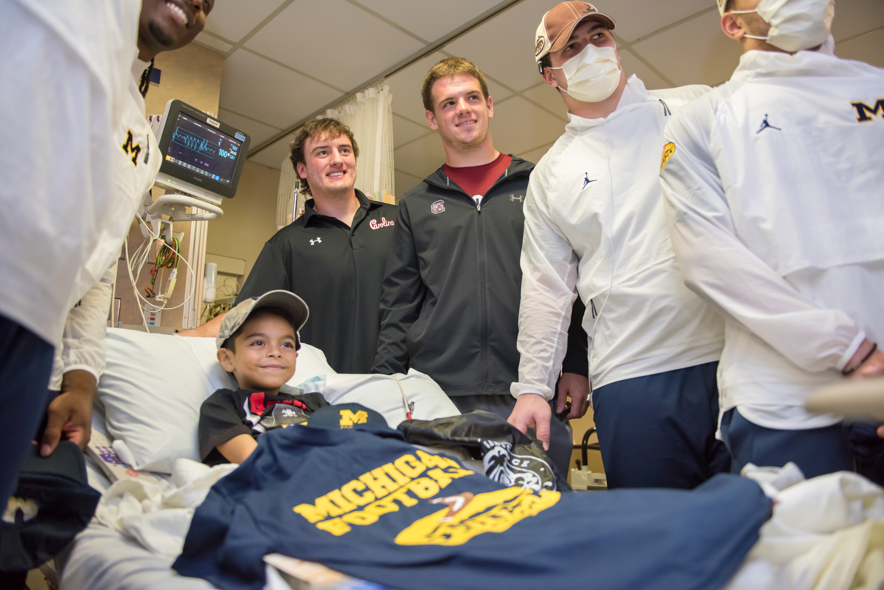 Outback bowl players visits young male patient