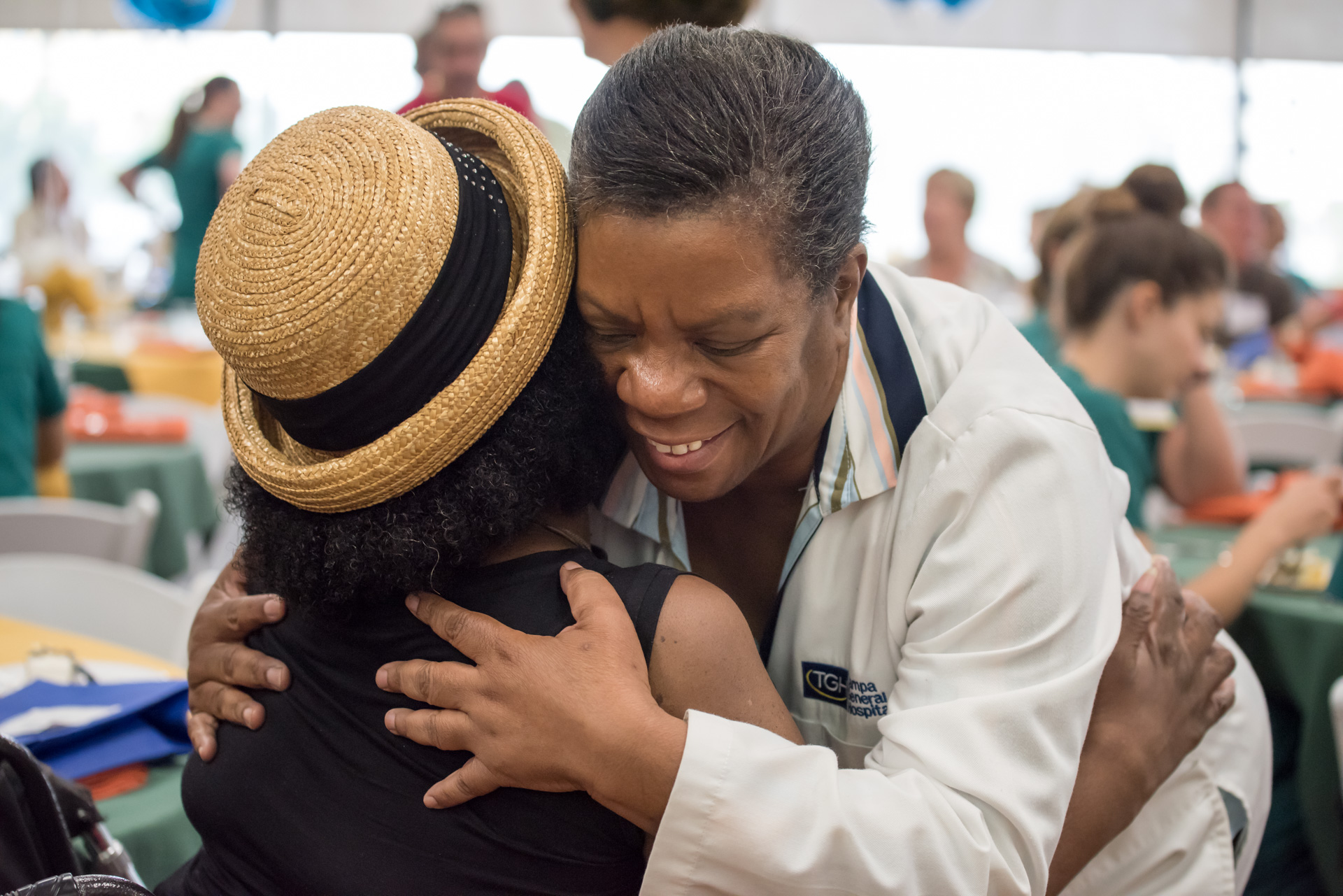 female physician hugging a female patient at the fall rehab reunion