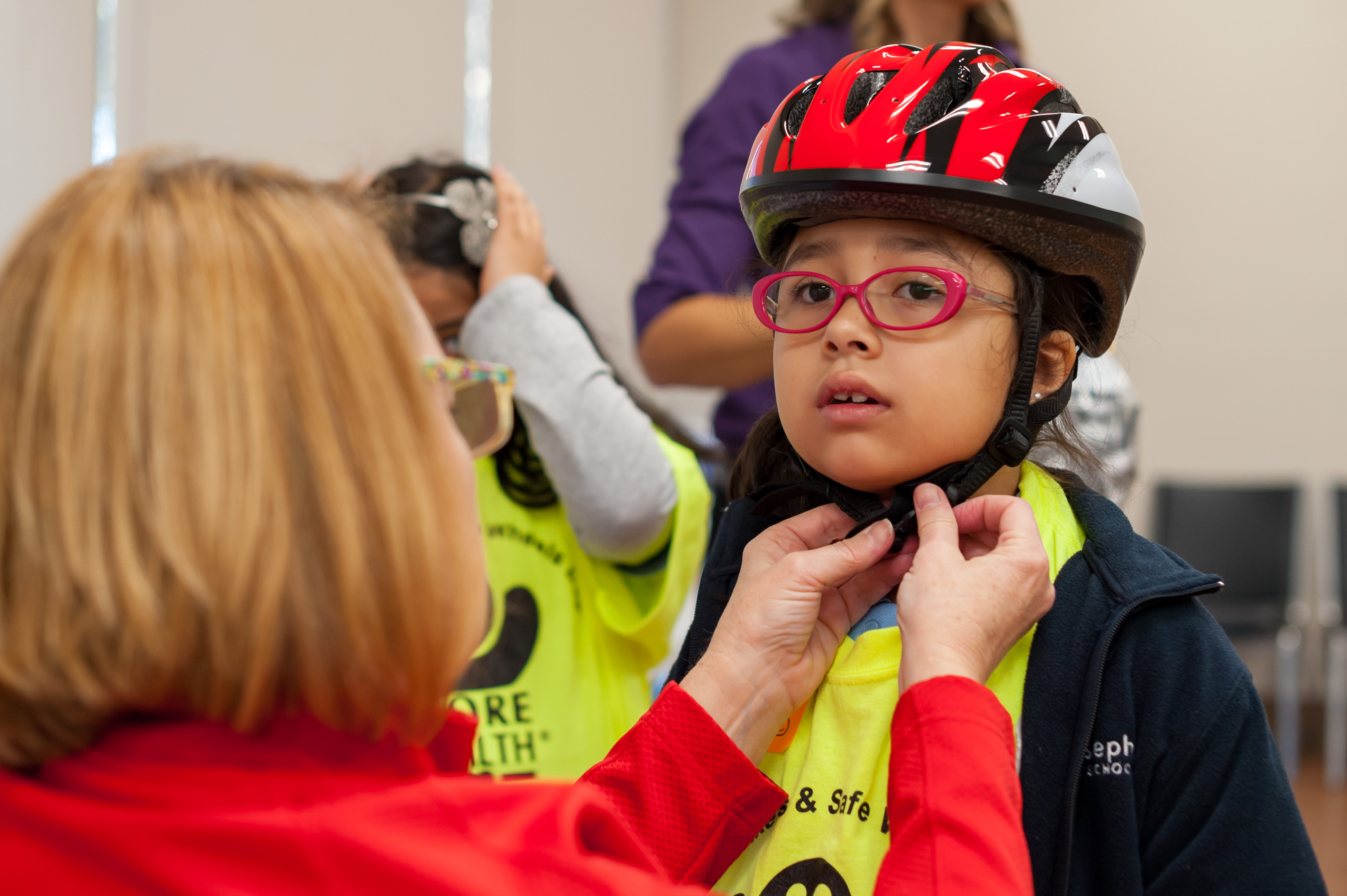 Girl trying on a helmet with More Health