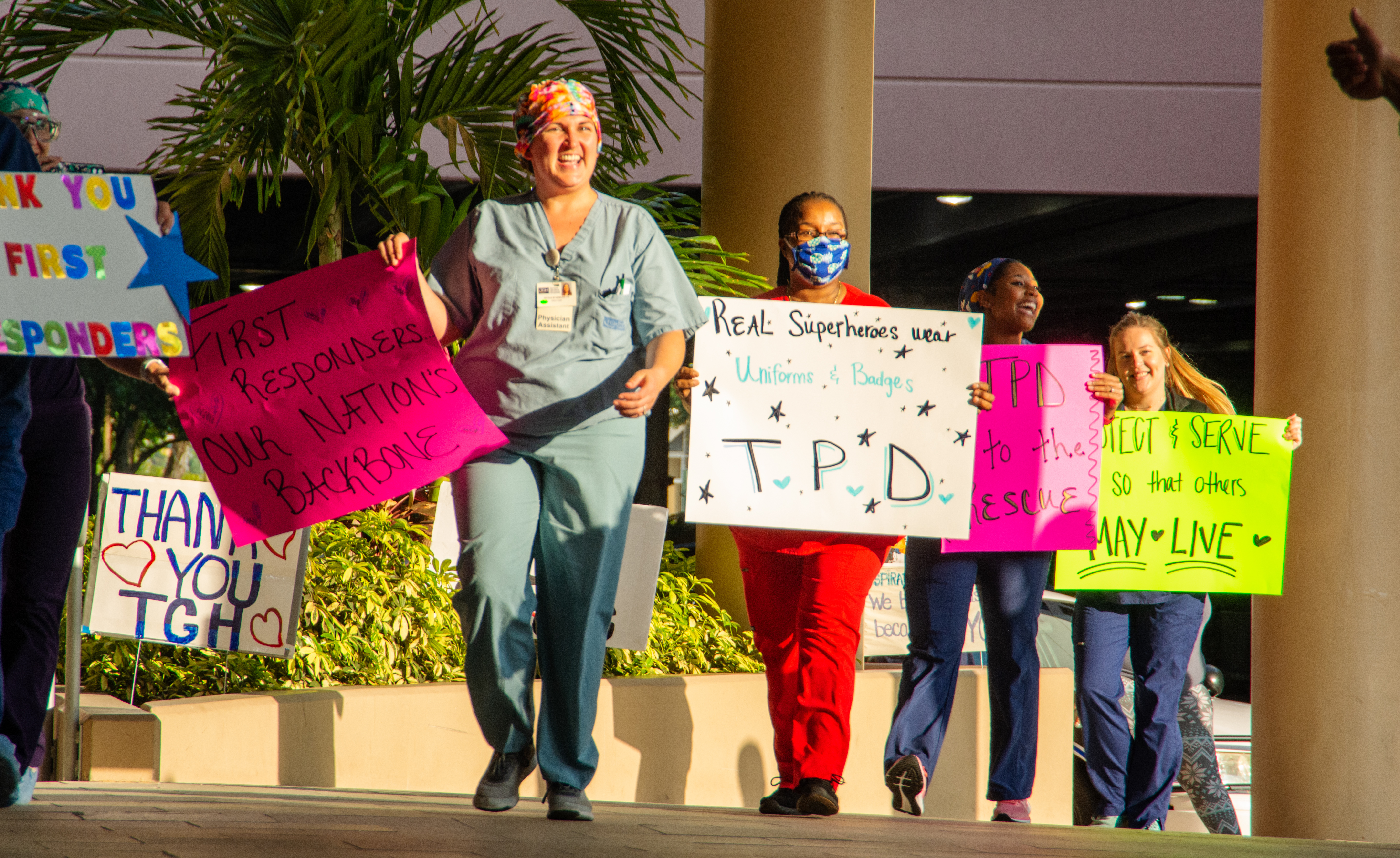 TGH staff walking out with their own signs of thanks