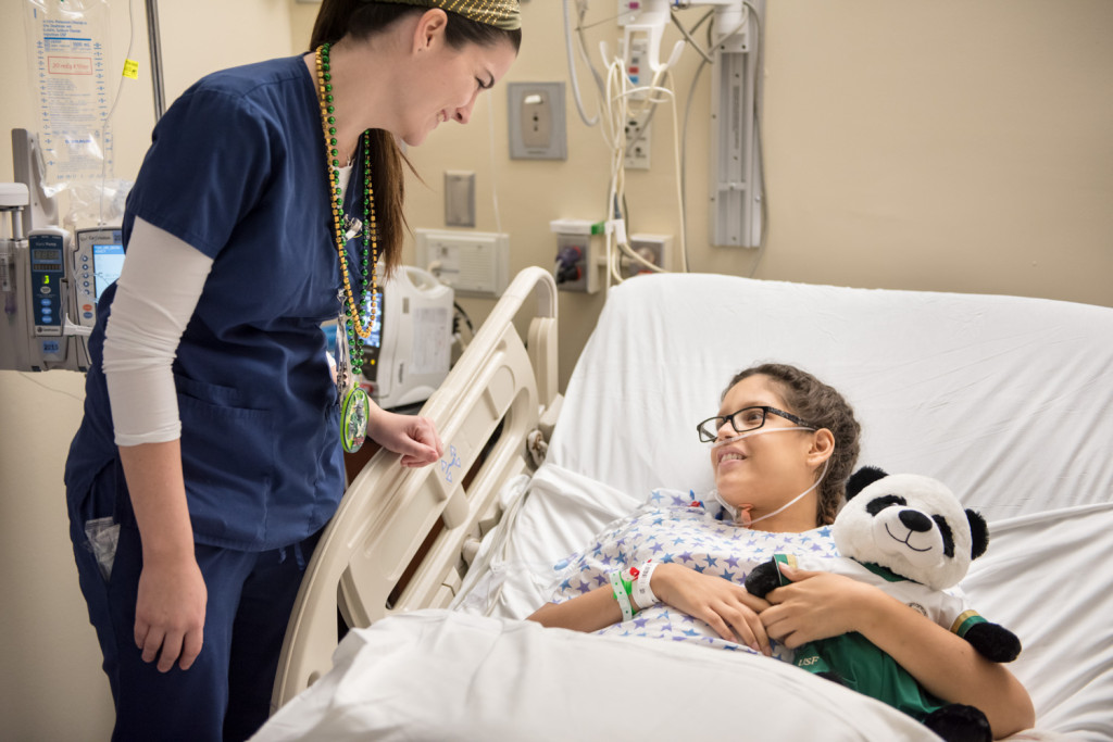 University of South Florida alum and Tampa General Hospital nurse Janel Canty, left, talks to Juliana Garcia as nursing students and alumni from USF visit TGH to deliver custom panda bears to patients in the Children’s Medical Center on Friday, Dec. 4, 2015.