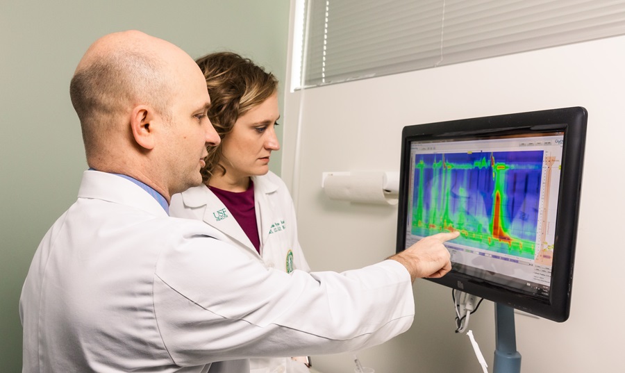 john jacobs, md views graph on monitor with female colleague at the tgh center for swallowing disorders