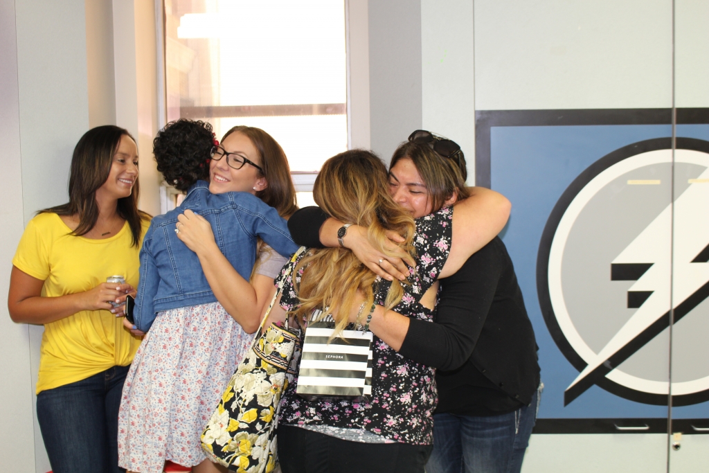 Group of girls hugging after ringing the chemo bell