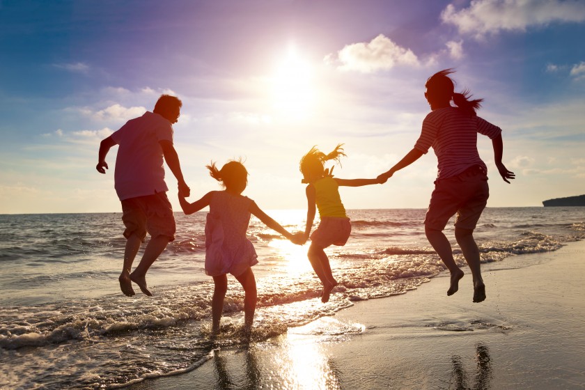 family_on_beach_jumping_active