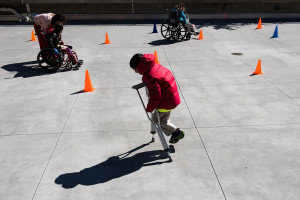 USF Patel Partnership first grader Zayd, 6, tries to keep one foot off the ground as he learns how to walk with crutches.