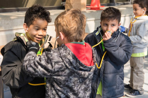 USF Patel Partnership first graders Taj, 7, from left, Charlie, 6, Adam, 7, and Jordan, 7, discover how to use a stethoscope.