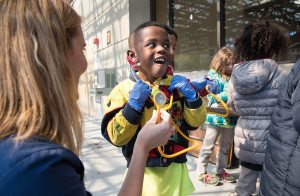 Rehab nurse manager Melissa Figueroa shows USF Patel Partnership first grader Malachi, 6, how to listen to his heart using a stethoscope.