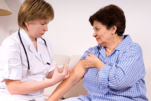 Nurse giving a woman a flu shot