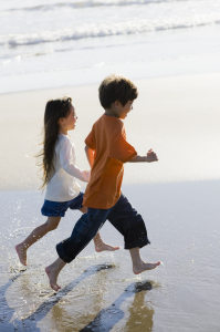 Kids run on the beach