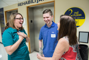 Tampa General Hospital speech therapist Lisa Stanley, left, sees former patient Ryan Mertens, 25, and his mom Jordan Mertens at the Rehabilitation Reunion.