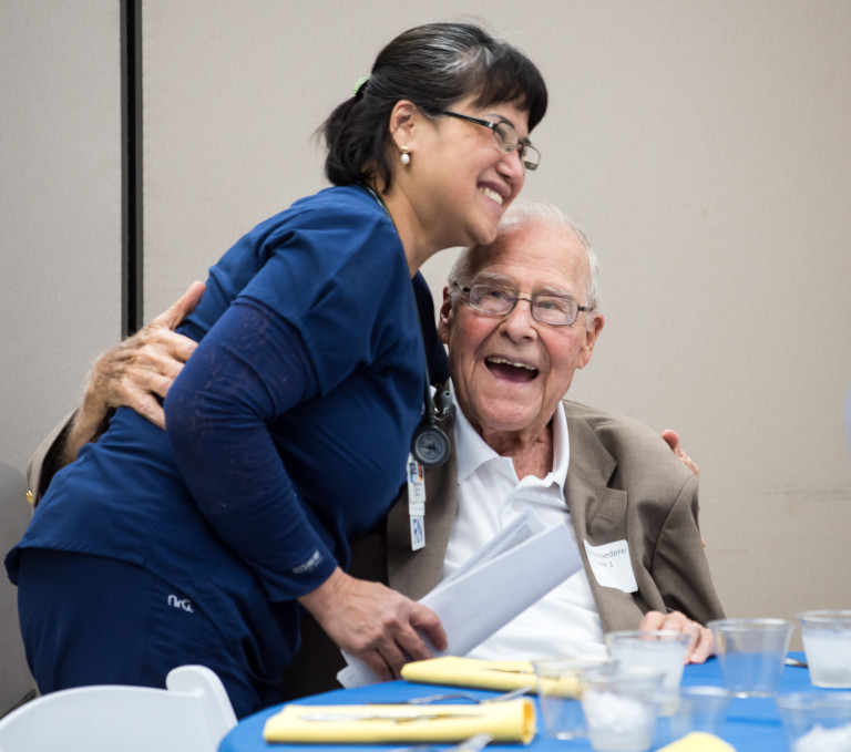 Clinical nurse Christina Pham hugs former patient Charlie Roederer at the reunion lunch.