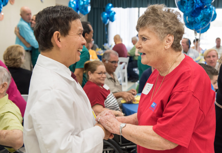 Dr. Venerando Batas talks to former patient Virginia Sue Mansker at the Rehabilitation Reunion.