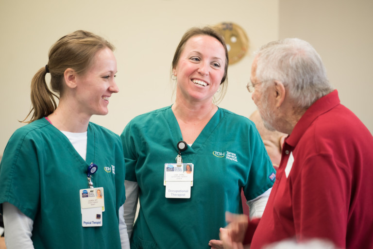 Physical Therapist Lauren Lindiakos, left, and occupational therapist Lisa Clark talk to former patient Fred Plumb at the Rehabilitation Reunion.