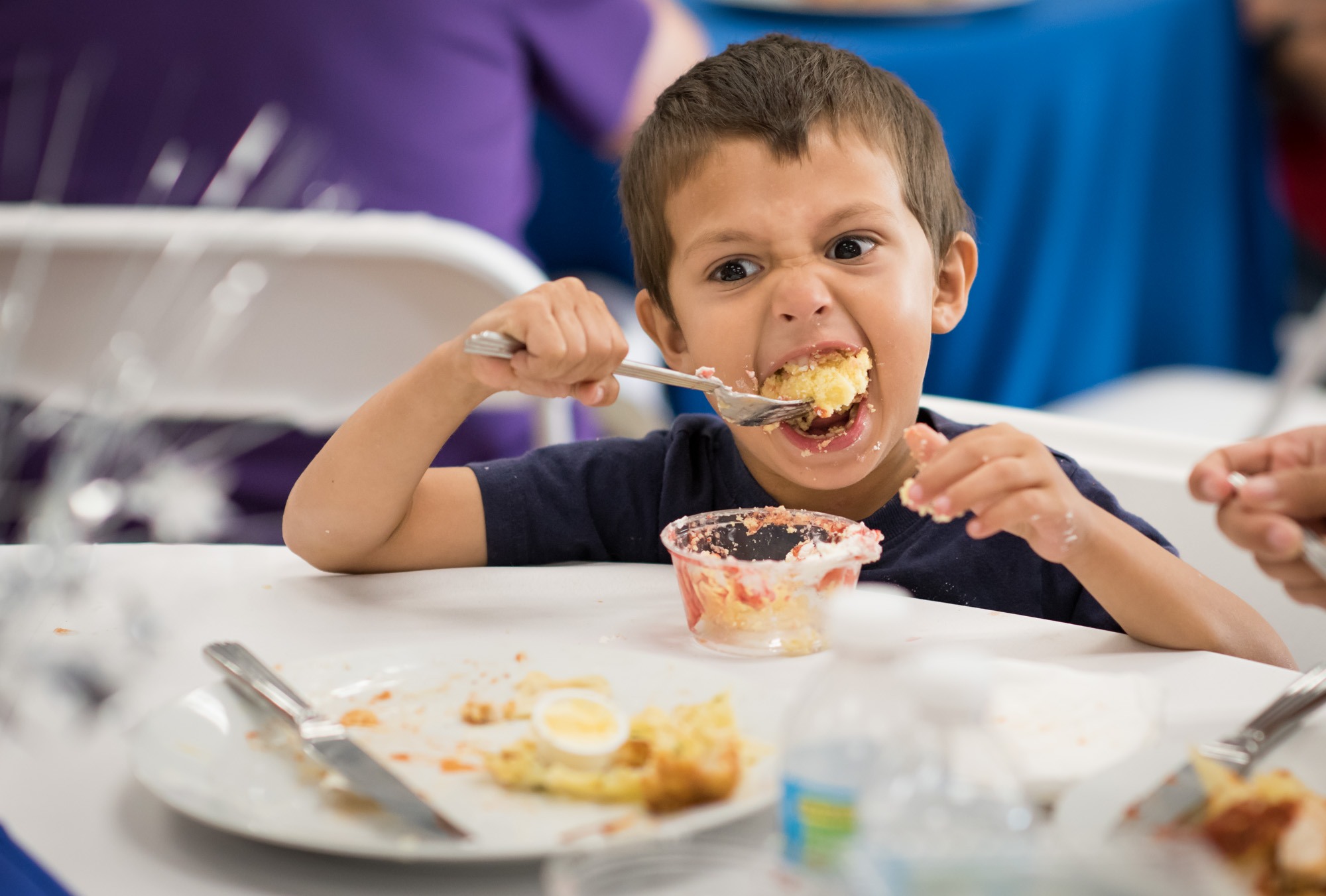A young boy eating dessert at the trauma awareness luncheon