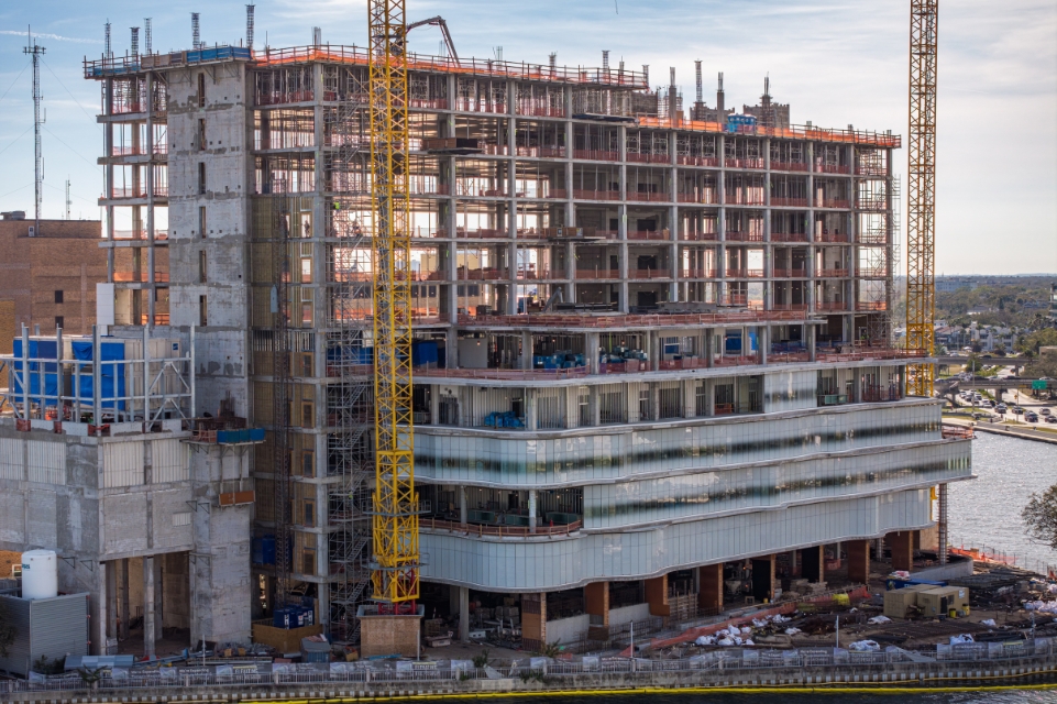 tgh Taneja Surgical, Neuroscience & Transplant Tower under construction with waterway and residential neighborhood in background